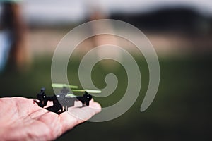 Miniature toy remote controlled drone taking off from a hand