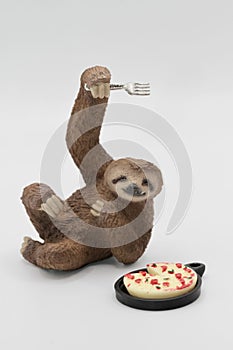 miniature toy sloth with pizza