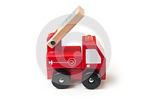 Miniature toy, wooden fire truck on white background