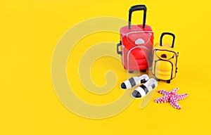 Miniature traveler accesories on yellow background