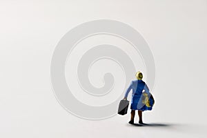 Miniature traveler woman with suitcases