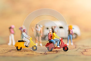 Miniature Travelers with two motorbikes. Drive through the front of backpackers on world map, using as a travel business concept photo