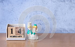 Miniature Wedding couple with wooden calendar 14 february. Valentine s day