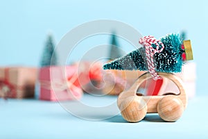 Miniature wooden car carrying a Christmas tree