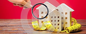 Miniature wooden houses and measuring tape. Home appraisal and property valuation concept. Housing construction, repair and