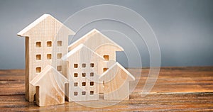 Miniature wooden houses. Real estate. City. Agglomeration and urbanization. Market Analytics. Demand for housing. Rising and