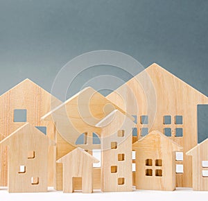 Miniature wooden houses. Real estate. City. Agglomeration and urbanization. Real Estate Market Analytics. Demand for housing.