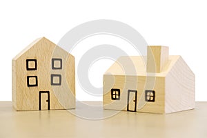 Miniature wooden houses on white background. Clipping paths incl