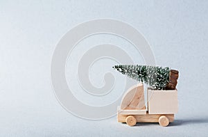 Miniature wooden truck with x-mas tree on is top