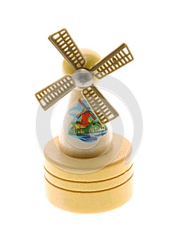 Miniature wooden windmill souvenir on white backgr