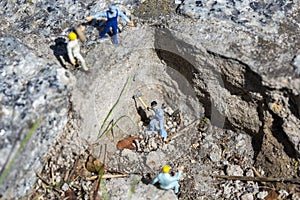 Miniature worker with a hammer working in a quarry
