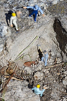 Miniature worker with a hammer working in a quarry