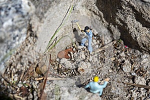 Miniature worker with a hammer working in a quarry