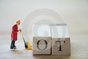 Miniature worker working under the time pressure at work, overtime concept