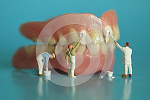 Miniature Workers Performing Dental Procedures. Dental Office Ar