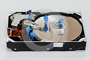 Miniature workers repair hard disk drive