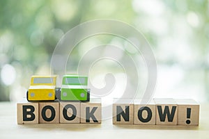 Miniatures car and words with book now. Concept of online car booking