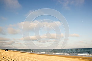 Minibus Car going far away at yellow sand seaside blue sky white