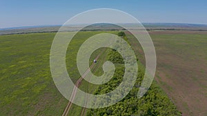 The minibus drives through the green field next to the boarding station. Aero