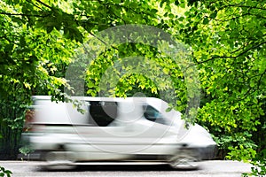 Minibus in motion on a forest road