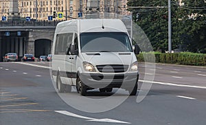 Minibus moves along the street in the city