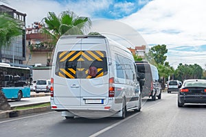 Minibuses hurry drive rush along the highway in dense traffic of other cars in the city street