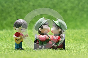 Minifigure young couple kissing with musician playing guitar.