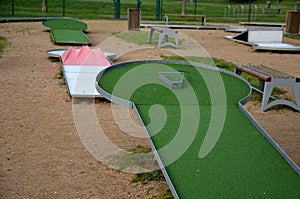 minigolf course in park catch golf balls behind obstacle.
