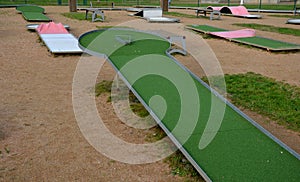 minigolf course in park catch golf balls behind obstacle.