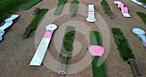 minigolf course in park catch golf balls behind obstacle. game for points