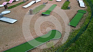 minigolf course in park catch golf balls behind obstacle. game for points