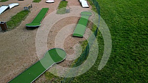 minigolf course in park catch golf balls behind obstacle. game for points