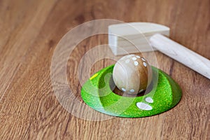 Minigolf wood for kids. Golf club and a ball during a mini golf game. Children`s Games at Home