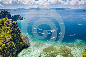 Miniloc island, Palawan, Philippines. Aerial view of tourism day trip boats on island hopping tour at big lagoon photo