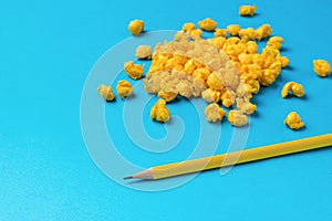 Minimal business concept. A bunch of crumpled pieces of paper and a yellow pencil on a blue background