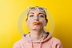 Minimal caucasian woman portrait with brown eyes and purple sunglasses. Funky creative concept with copy space