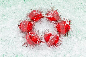 Minimal composition of fluffy red balls on snow white background.New Year and Christmas concept