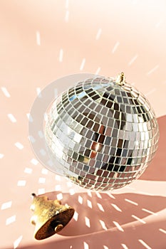 Minimal creative. Christmas decorations and mirror disco balls on sand color background