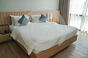 Minimal double bed with white mattress in luxury hotel bedroom