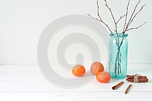 Minimal elegant composition with tangerines and vase