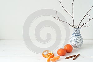Minimal elegant composition with tangerines and vase