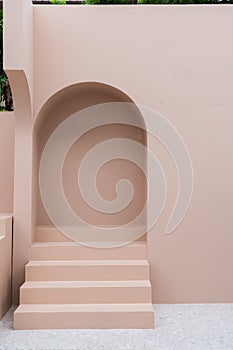 Minimal empty space scene with pink painted wall and little step with arc  for photoshoot in natural light scene / studio concept