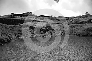 Minimal monochromatic view of lake and rock mountains