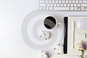 Minimal Office desk table with Keyboard computer, coffee cup, mouse, white pen, cotton flowers, eraser on a white table with copy