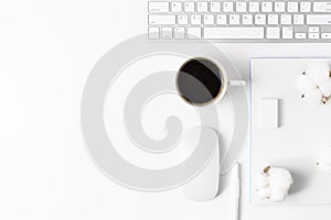 Minimal Office desk table with Keyboard computer, coffee cup, mouse, white pen, cotton flowers, eraser on a white table with copy