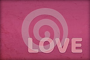 Minimal romantic love creative concept for Valentine`s day, wedding. Pink gloss word on textured background red pear, jester red