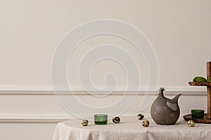 Minimal spring composition of easter living room interior with copy space, beige wall with stucco hen sculpture, green glass,