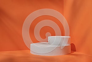 Minimal stage for a modern product display on a white podium cilinre on an orange background.