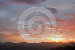 Sky with intense and warm coulor when sunset over Tuscany hills photo