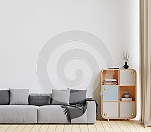 minimal style living room with wooden floor ,white wall,big grey couch sofa,big window,carpet,wooden cabinet
